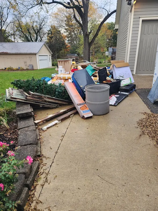 Dumpster being loaded with debris for Estate Cleanout Dumpster Rental in Winslow
